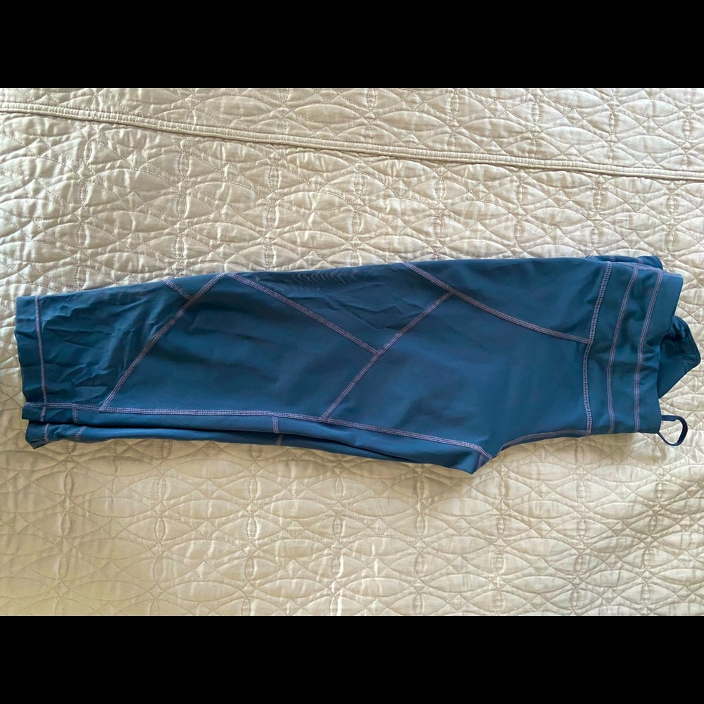 Blue, Athleta workout pants with peekaboo cut outs. Crop/mid calf